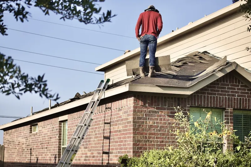 Professional roofer working on a residential roof in Pikes Peak Park